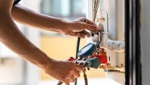 technician repairing heating unit technician repairing heating unit
